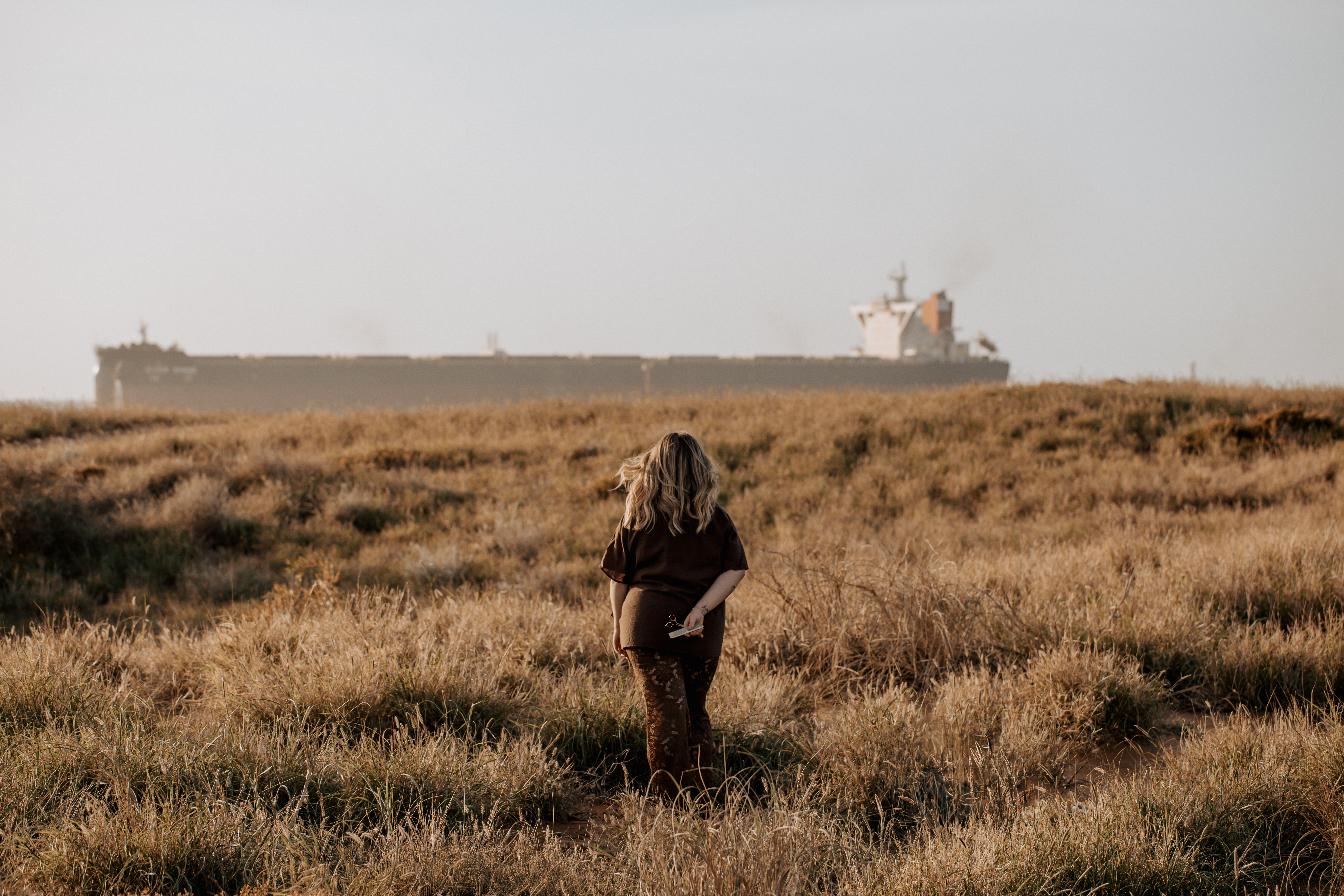 Kate Bonnie, hairdresser for Port Hedland, standing in the Pilbara landscape